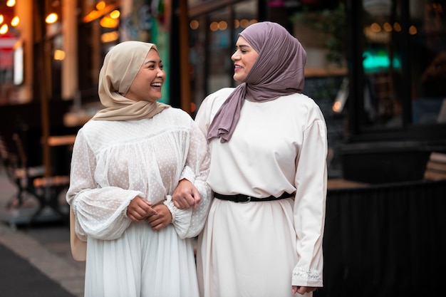 Free photo women wearing hijab an having a good time