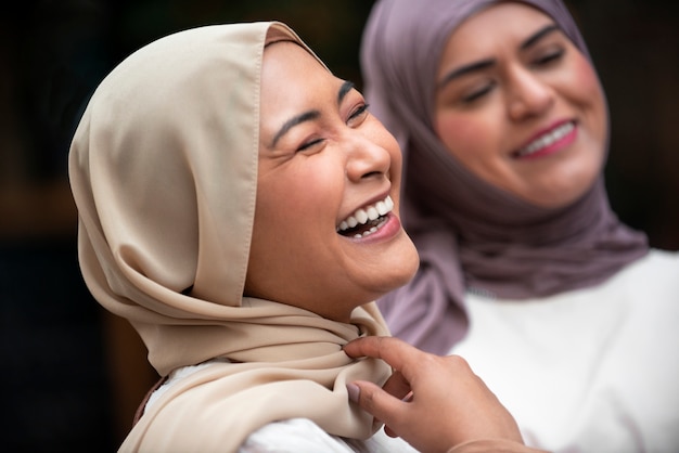 Free photo women wearing hijab an having a good time