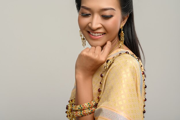 Women wearing Thai clothes and hands touching their faces