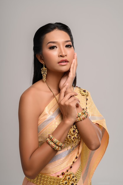 Women wearing Thai clothes and hands touching their faces