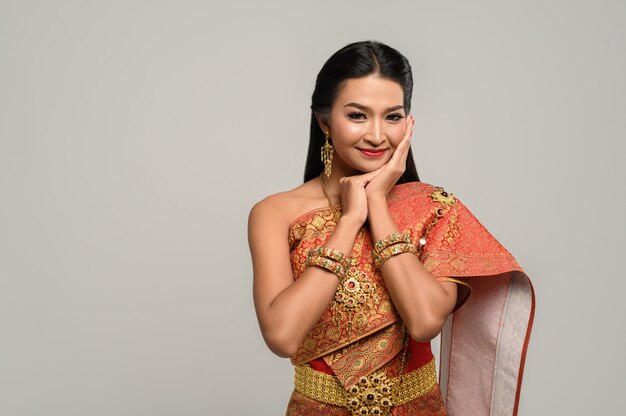 Women wearing Thai clothes and hands touching their faces