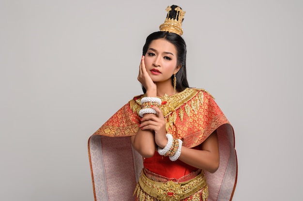 Free photo women wearing thai clothes and hands touching their faces