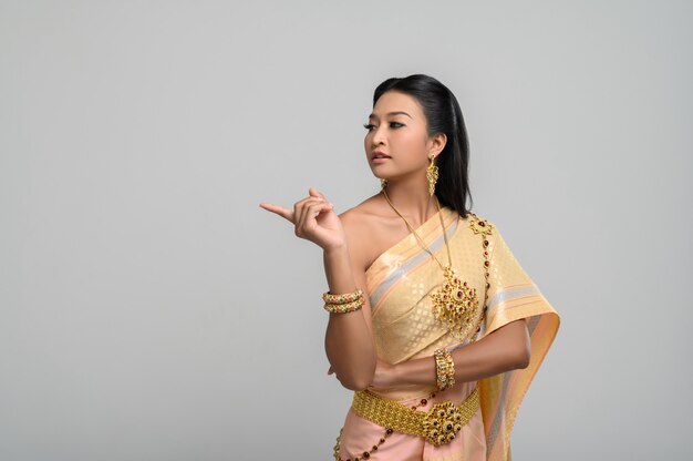 Women wearing Thai costumes that are symbolic, pointing fingers