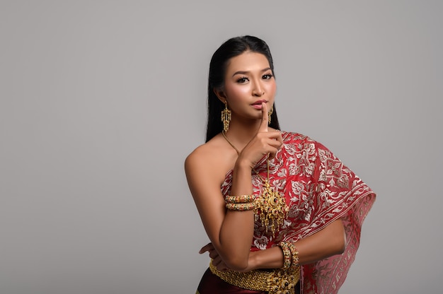 Women wearing Thai costumes that are symbolic, pointing fingers