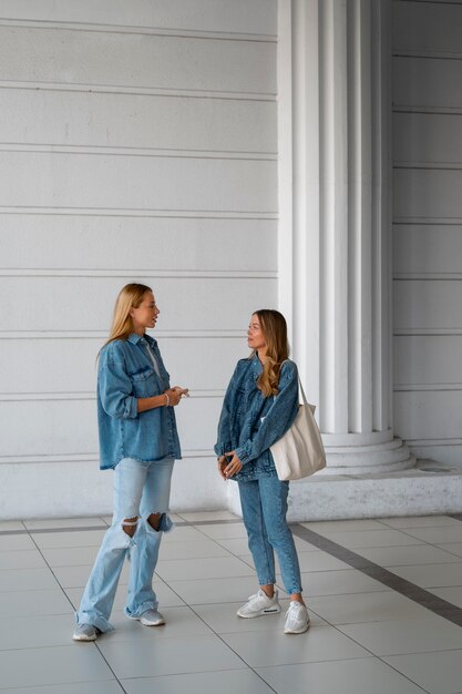 Women wearing total denim outfits full shot