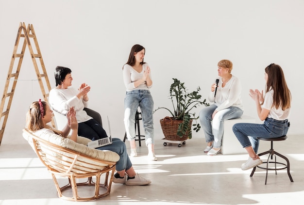 Women in white shirts in a wide room