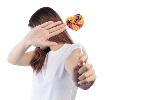 Free photo women who are against candy, isolated on a white background.