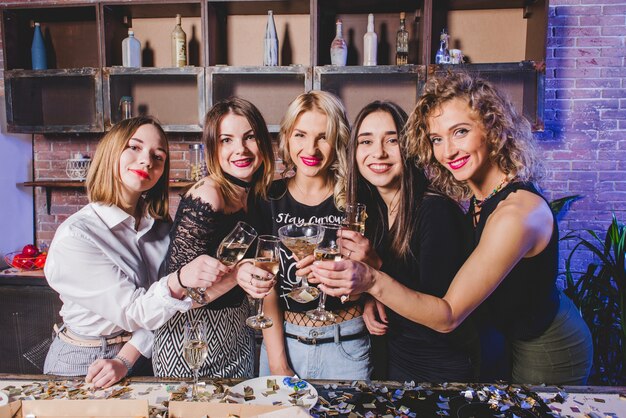 Women with champagne on kitchen