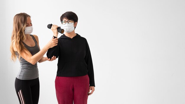 コピースペースでトレーニングするフェイスマスクを持つ女性