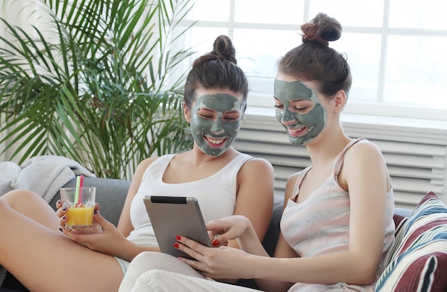 Free photo women with facial mask, beauty and skin care concept