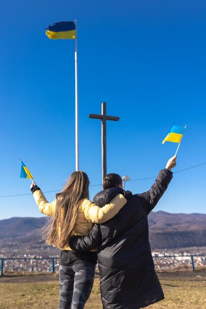 Женщины с флагами украины на фоне неба и гор
