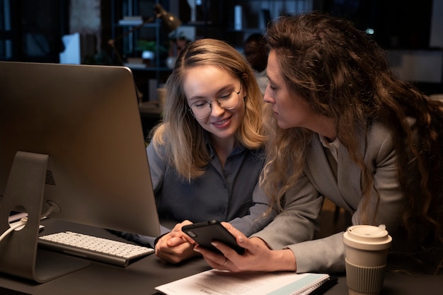 Free photo women with smartphone and computer