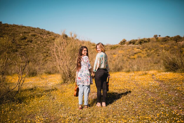 Women with ukuleles in amazing meadow