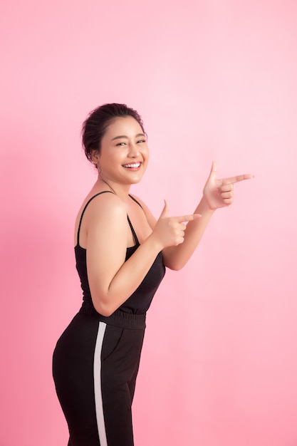 Free photo women with white empty board, pointing away