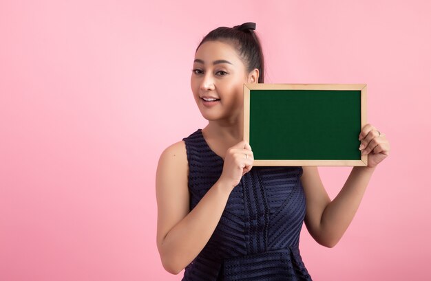 women with white empty board, pointing away