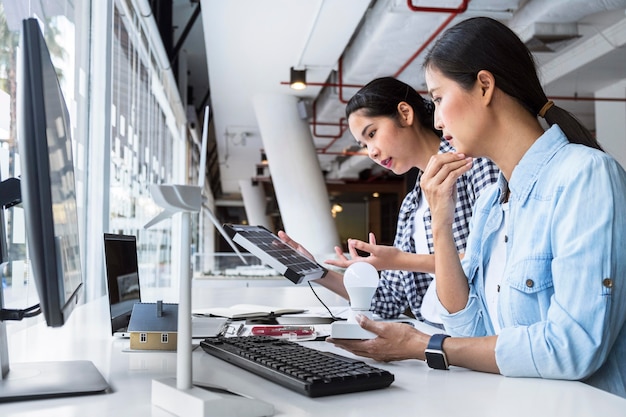 Women working hard together for an innovation at the office