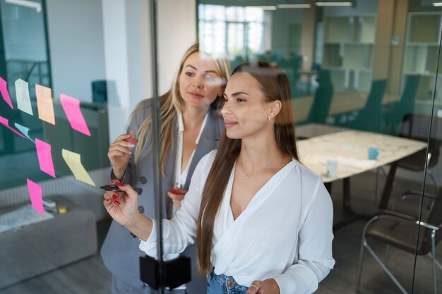 Women working with post-its medium shot