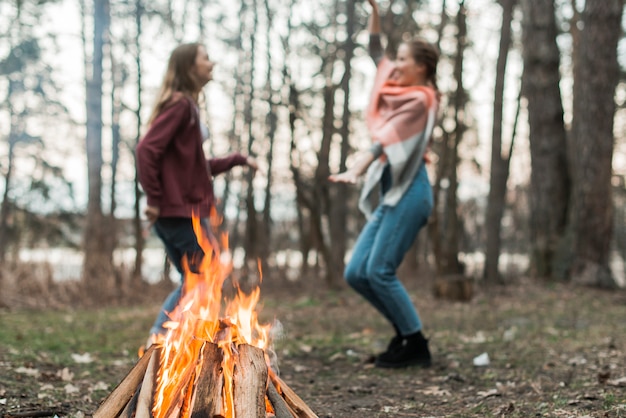 Womens dancing around bonfire
