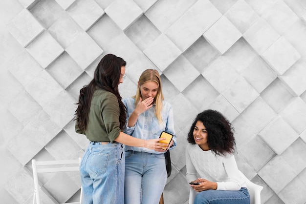 Womens at office looking on mobile