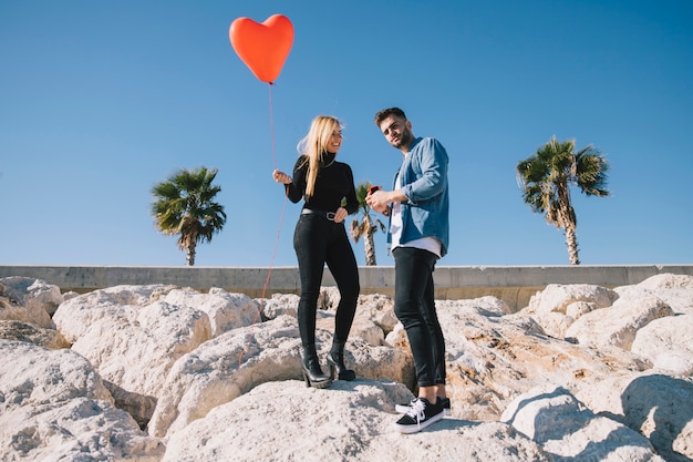 Free photo wonderful couple on rocky shore