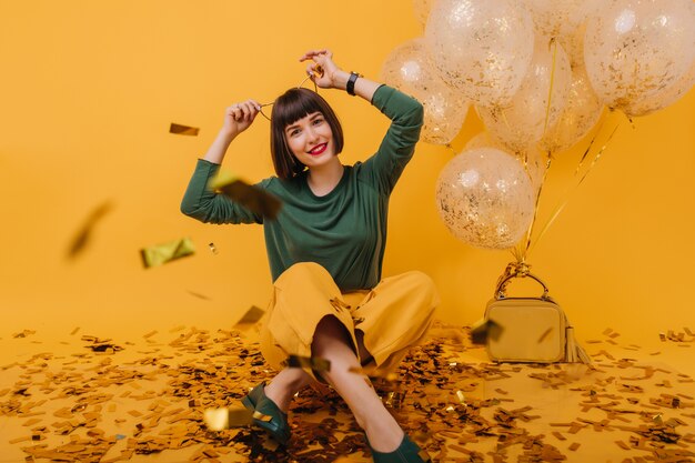 Wonderful girl with hair accessory posing. ecstatic brunette lady having fun in at birthday party.