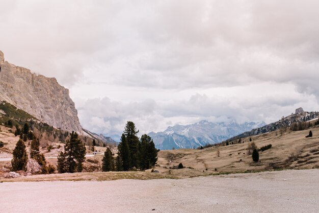 Wonderful view of distant high mountains and cloudy gray sky early in the morning