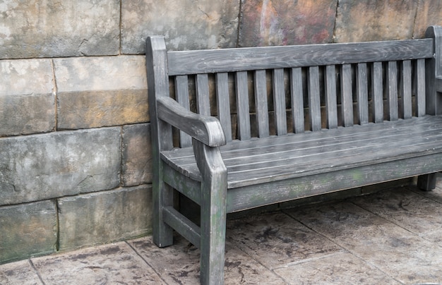 Wood Bench against concrete wall .