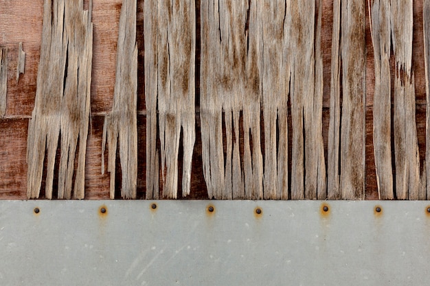 Wood chipping on aged surface with rusty nails