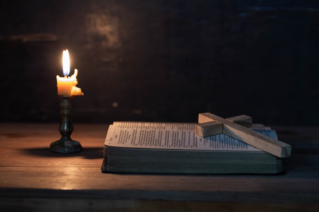 Wood cross laying on an opened Bible