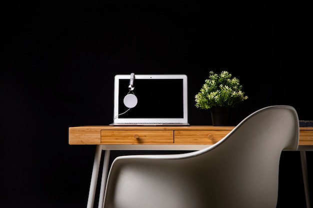 Wood desk with chair and laptop