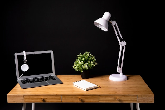 Wood desk with laptop and lamp