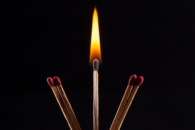 Wood match burning with dark background