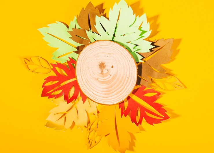Free Photo wood slice with paper leaflets 