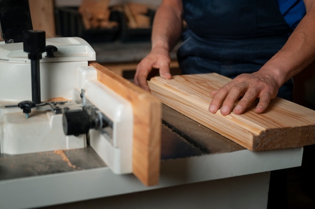 Free photo wood worker in his shop working with tools and equipment