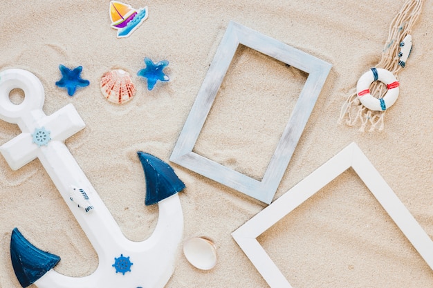 Wooden anchor with blank frames on sand