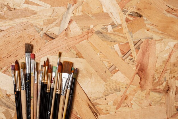 Wooden background and small paint brushes