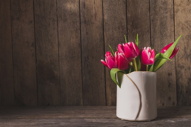 Wooden background with beautiful tulips