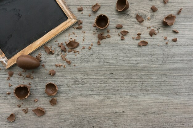 wooden background with chocolate eggs and slate