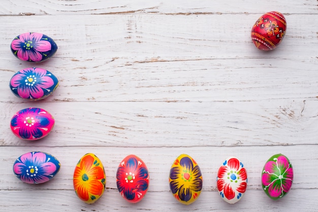 Wooden background with easter eggs composition