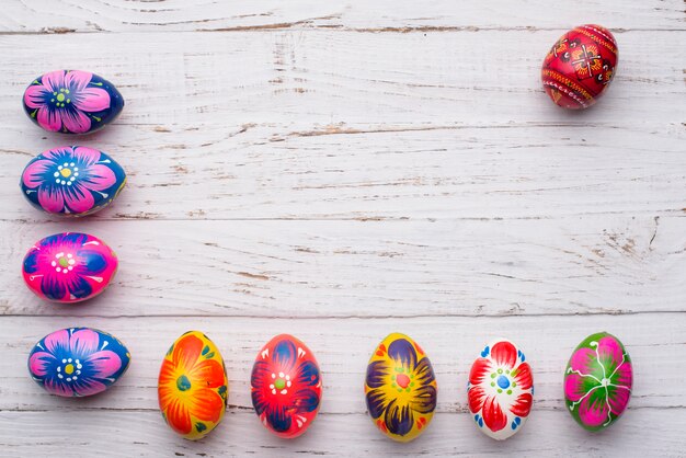 Wooden background with easter eggs composition