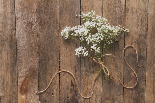 Free photo wooden background with floral decoration