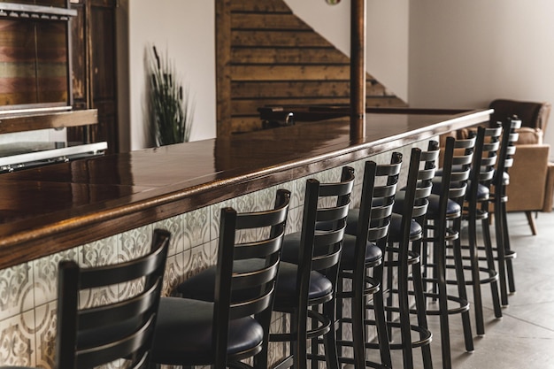 Wooden bar table with bar chairs in a cafe