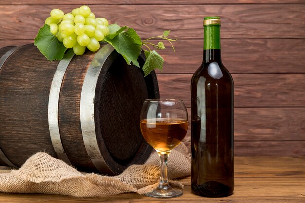 Wooden barrel with bottle and glass of wine