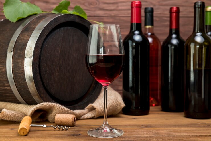 Wooden barrel with bottles and glasses of wine