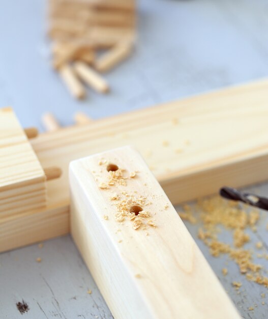 Wooden bars being drilled