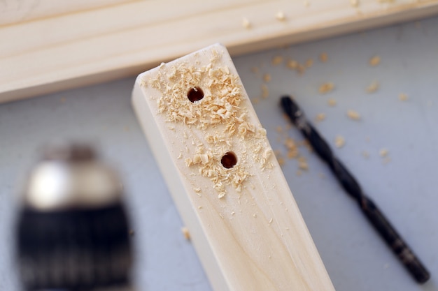 Wooden bars being drilled