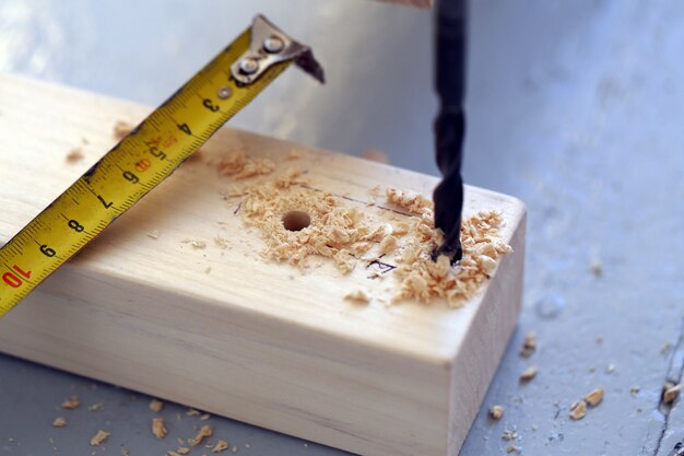 Wooden bars being drilled