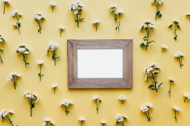 Wooden blank frame in flowers