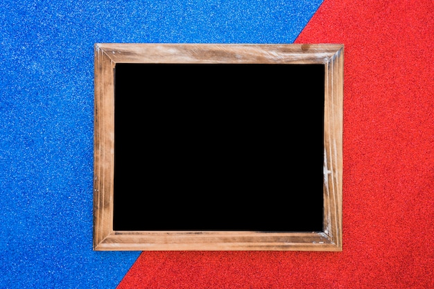 Wooden blank slate on dual blue and red backdrop