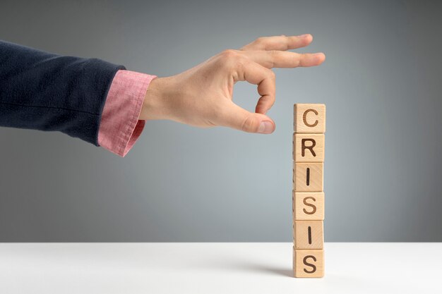 Wooden blocks with crisis mesage on desk